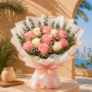 50 fresh red roses in a white-wrapped dome bouquet