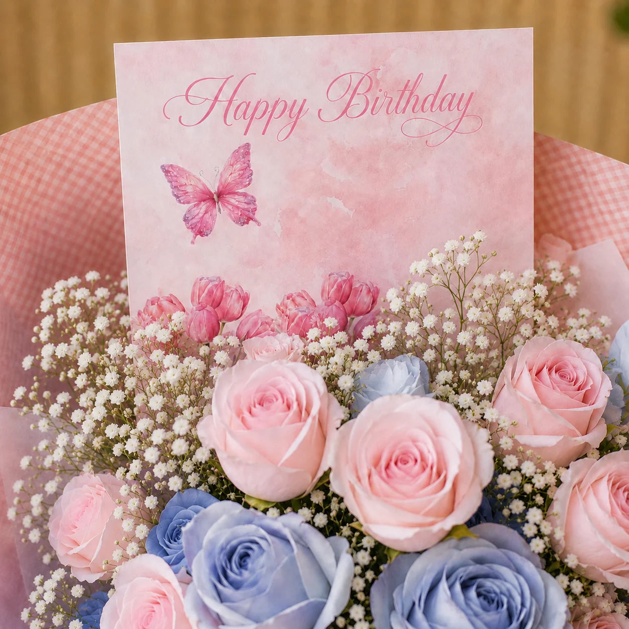 Birthday Flower with Blue and Pink Flowers with a card saying "Happy Birthday" with a butterfly