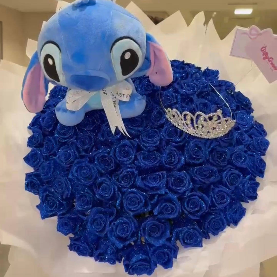 Blue Stitch on a heart-shaped arrangement of blue roses with a tiara.