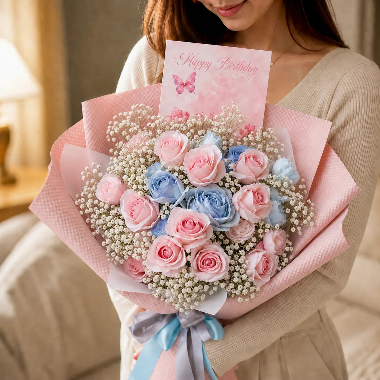 Girl holding a Birthday Flower with Blue and Pink Flowers with a card saying "Happy Birthday" with a butterfly