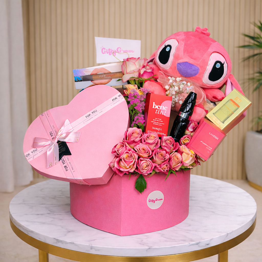 Pink floral arrangement with plush Stitch with makeup, on a marble table.